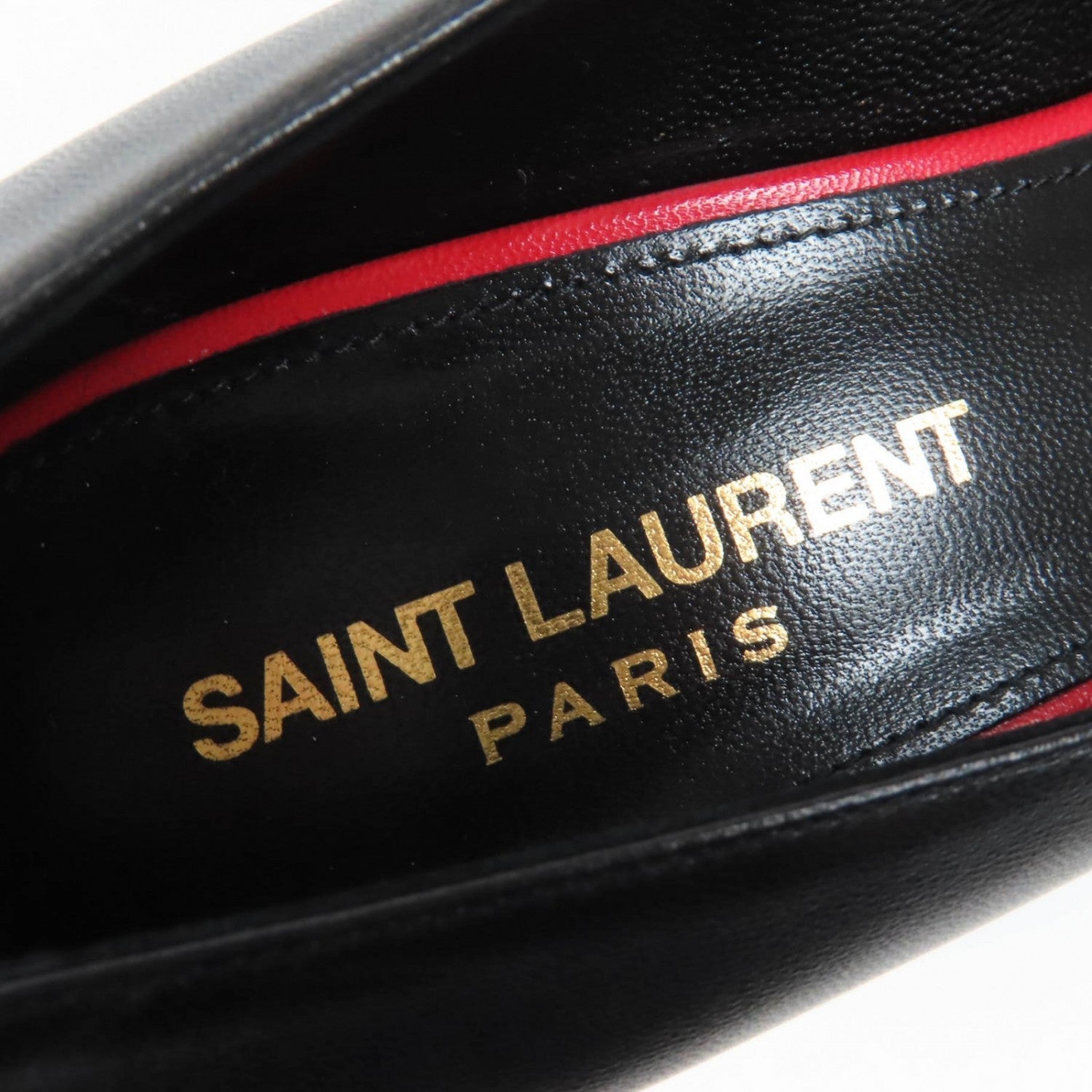 Inside view of Saint Laurent Paris black heels featuring luxurious leather and signature branding