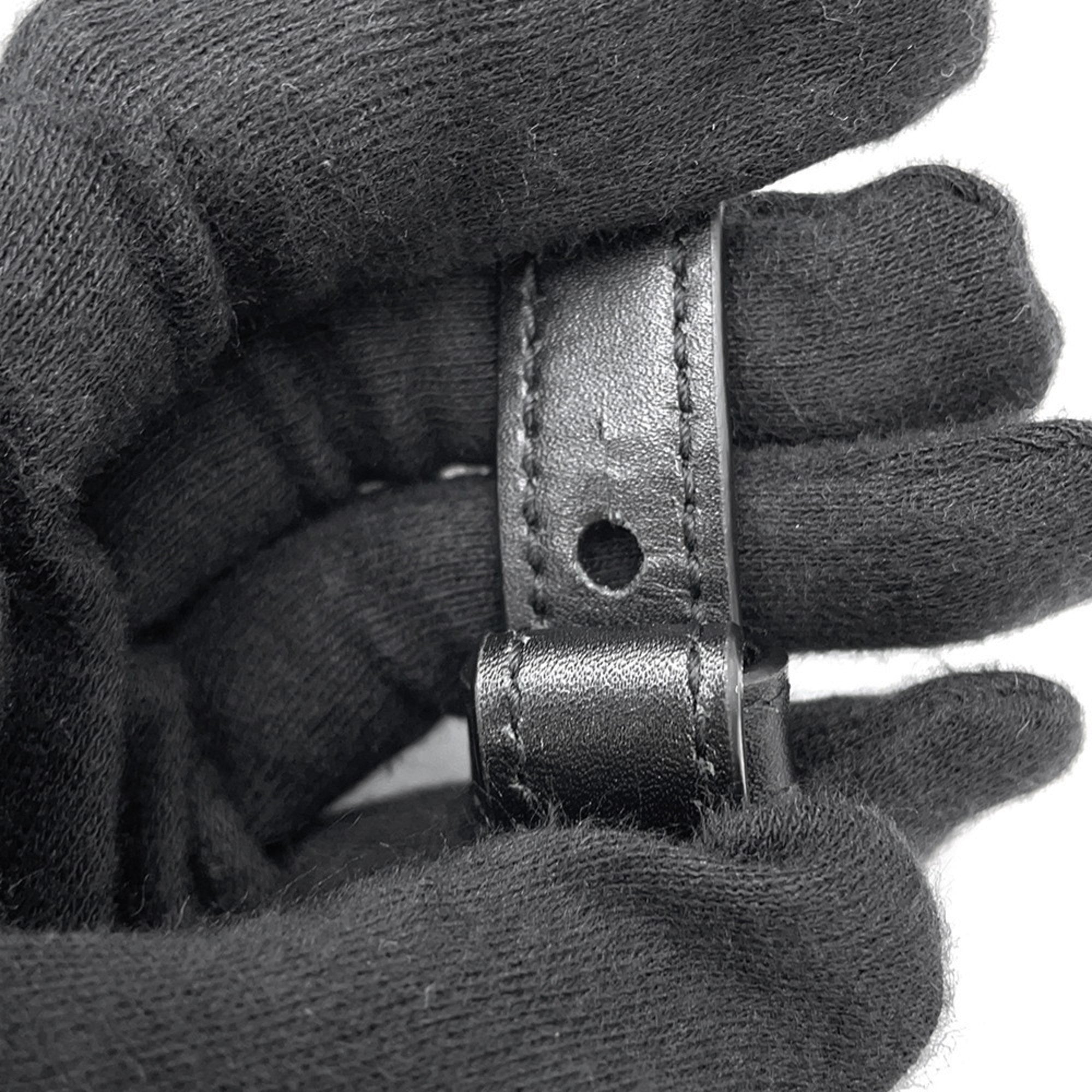 Close-up of MANSII SAINT LAURENT Seria Mini 2 way bag leather strap detail held in a gloved hand