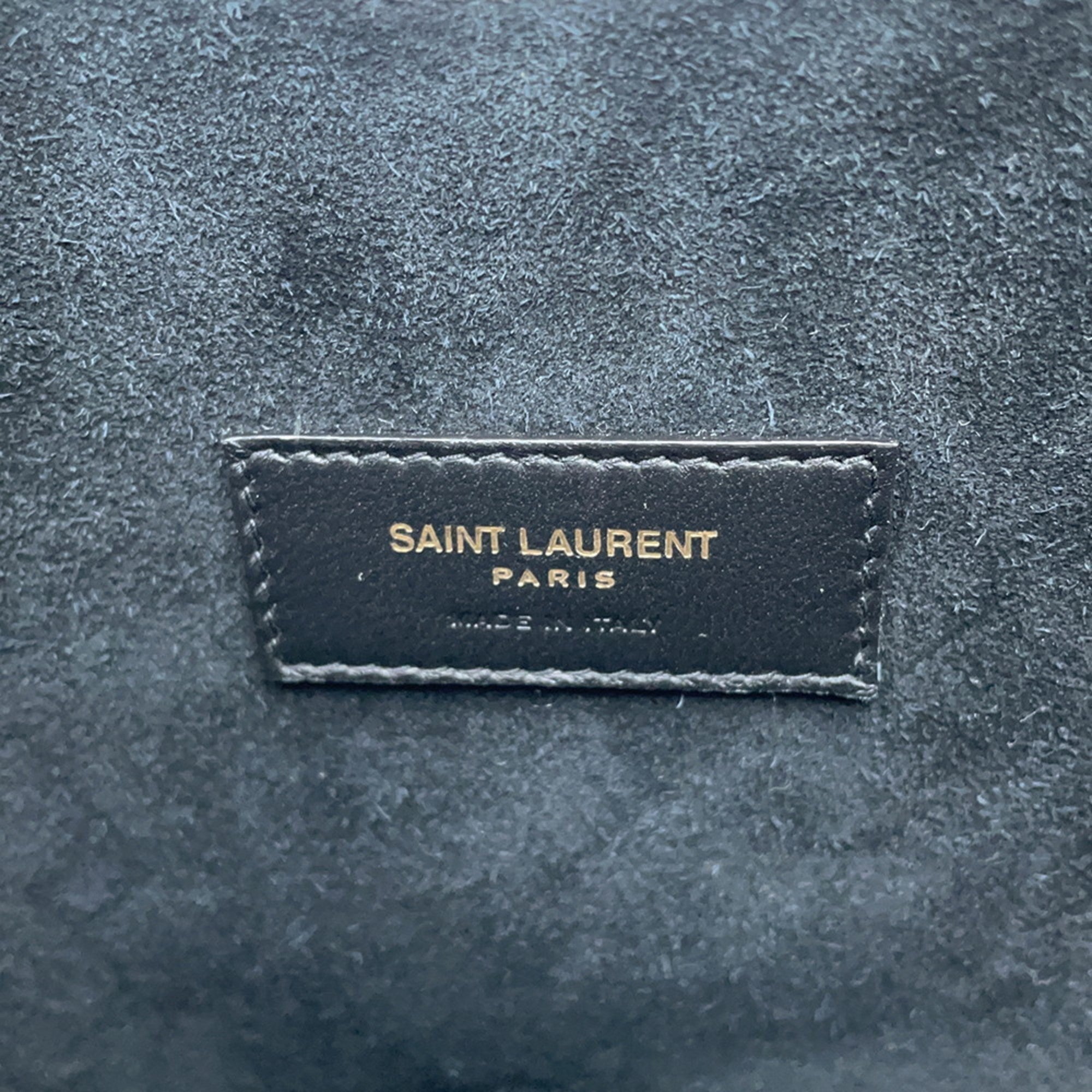 Close-up of SAINT LAURENT Seria Mini 2 way bag logo tag with premium suede texture