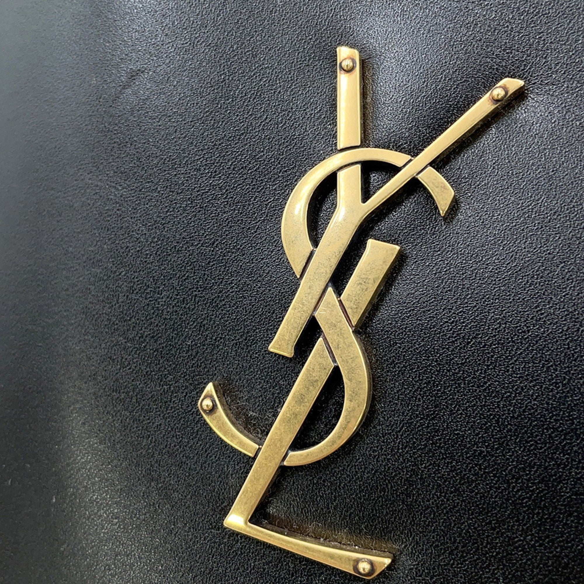 Close-up of the gold YSL logo on SAINT LAURENT Seria Mini 2 way bag showcasing luxury fashion details