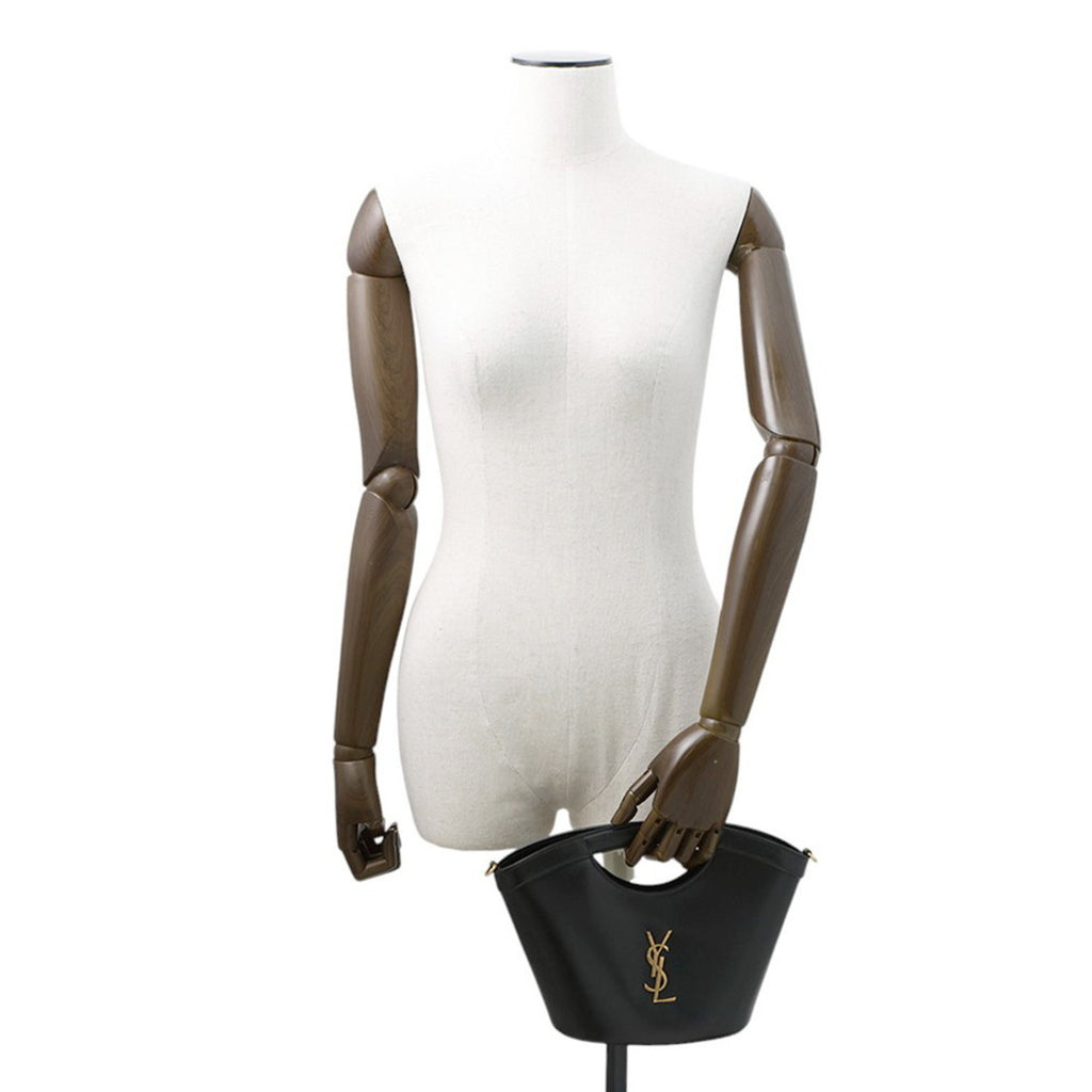 MANSII SAINT LAURENT Seria Mini 2 way bag in black with gold logo on a mannequin