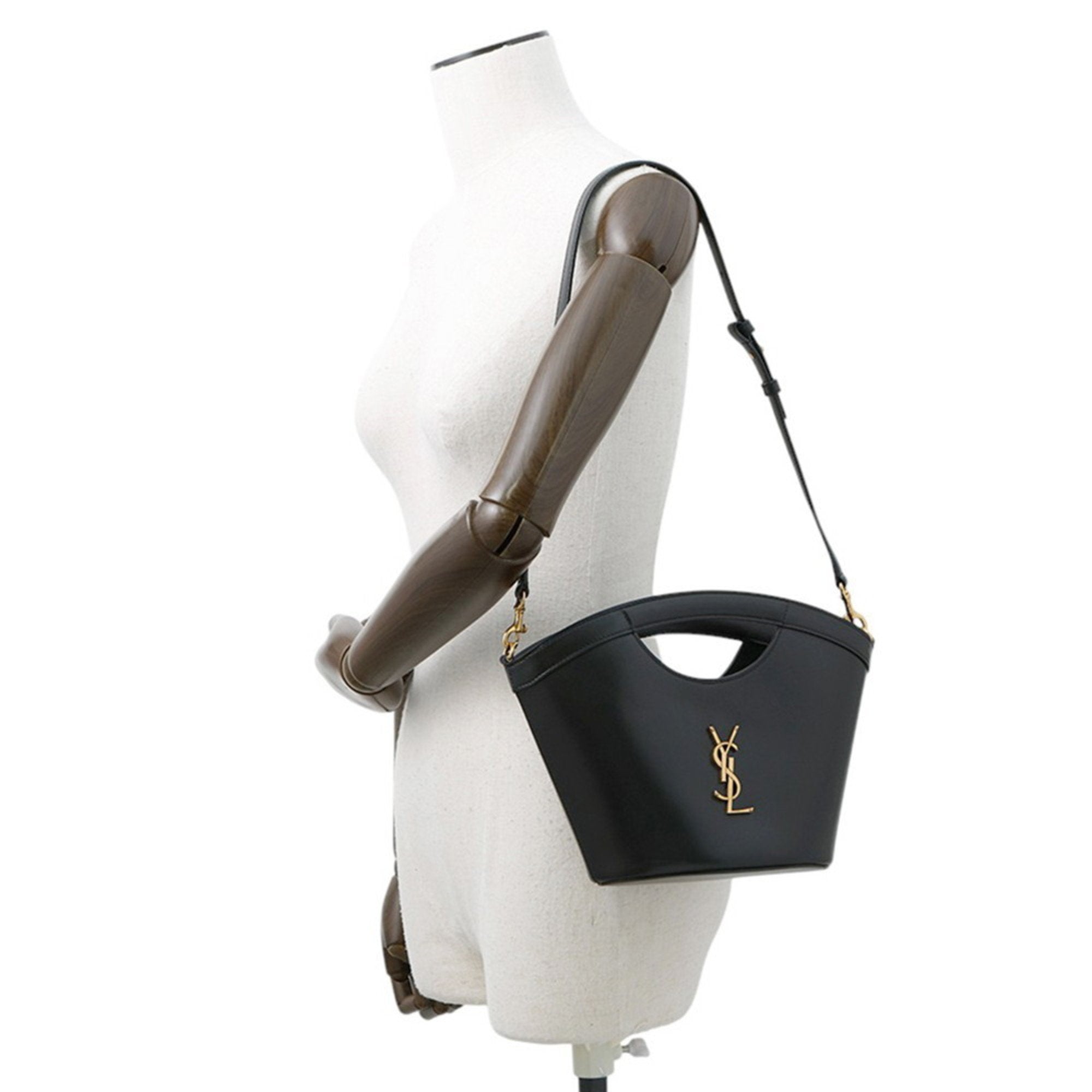 MANSII SAINT LAURENT Seria Mini 2 way bag in black with gold logo on a mannequin display