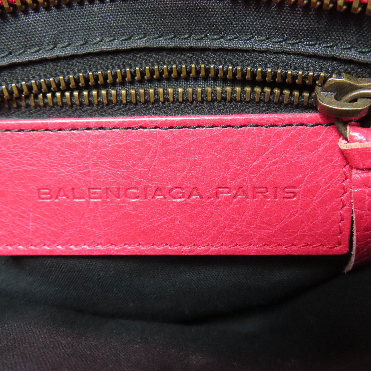 BALENCIAGA second hand bag interior showing the brand logo and zipper details