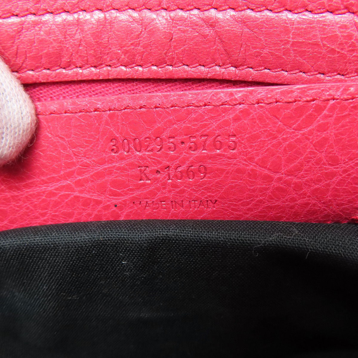 Balenciaga pink bag interior featuring second hand identification tag and high-quality leather craftsmanship