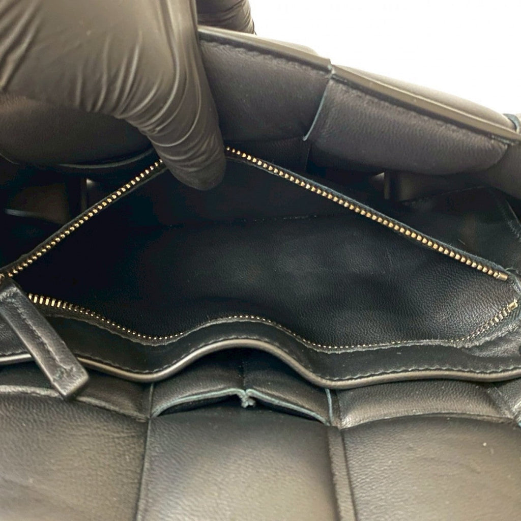 Interior view of a second hand Bottega Veneta bag showing zipped pocket and leather lining