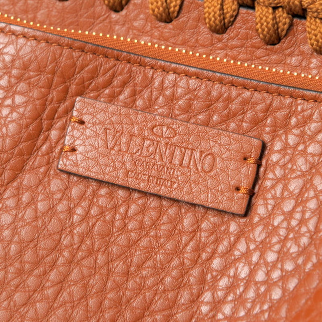 Valentino Garavani pre-owned leather bag with signature tag and textured finish