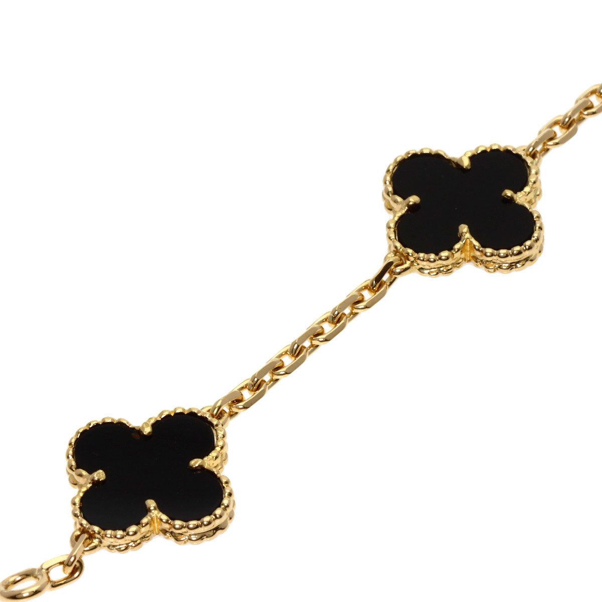 Used Van Cleef 18K gold bracelet featuring black onyx clover motifs for elegant styling