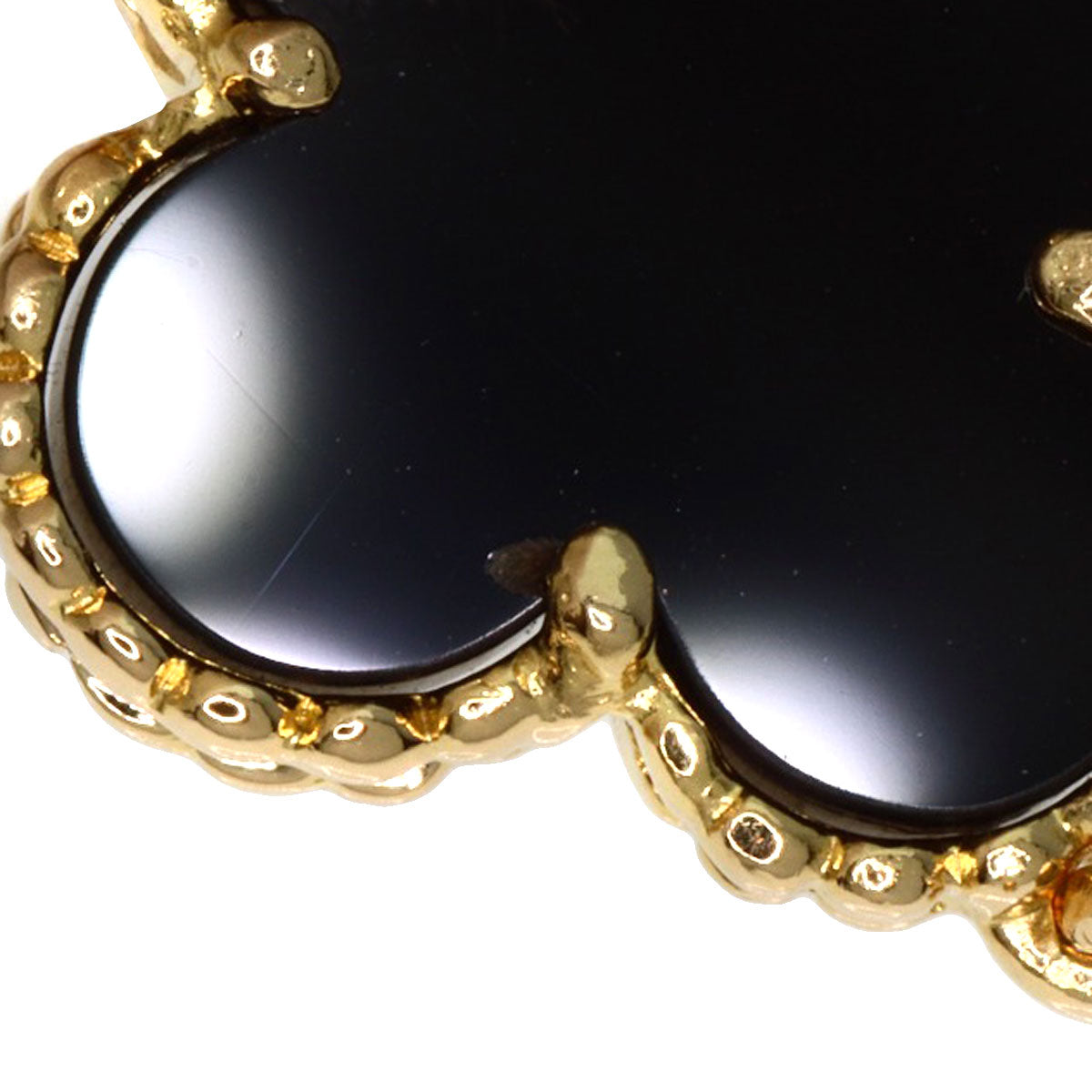 Close-up of a used Van Cleef 18K gold bracelet featuring a black onyx design with intricate detailing