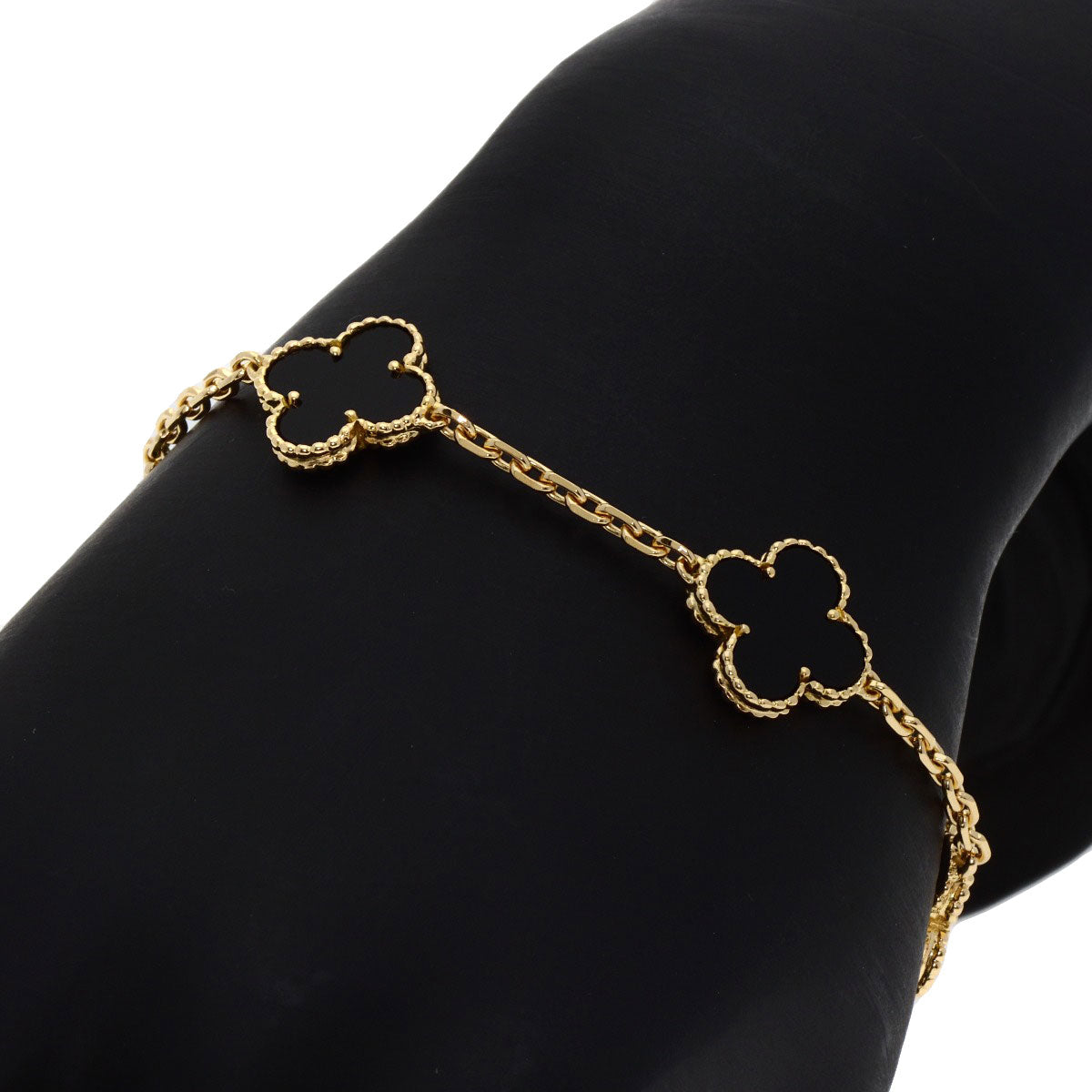 Used Van Cleef 18K gold bracelet featuring iconic clover motifs and delicate chain design