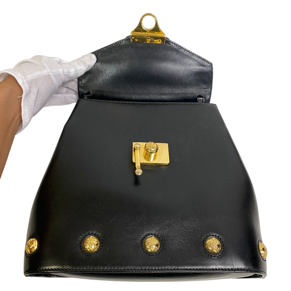 Salvatore Ferragamo vintage black bag with gold accents and clasp closure open to show interior