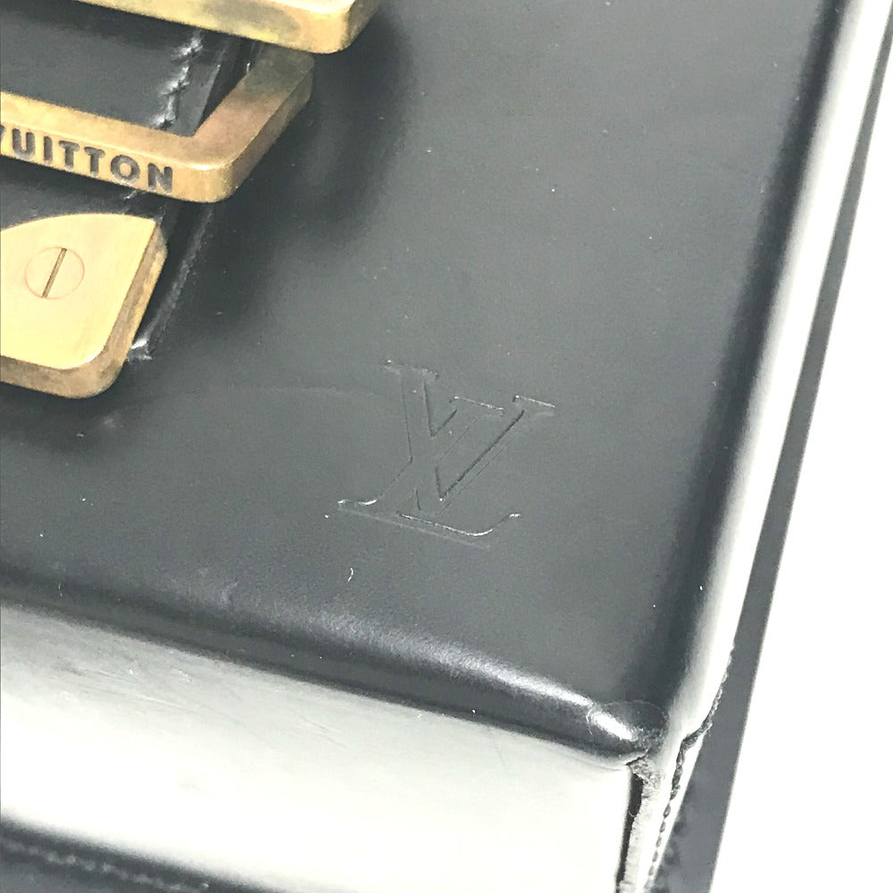 Close-up of a Louis Vuitton Vintage Pouch with gold hardware and embossed logo details