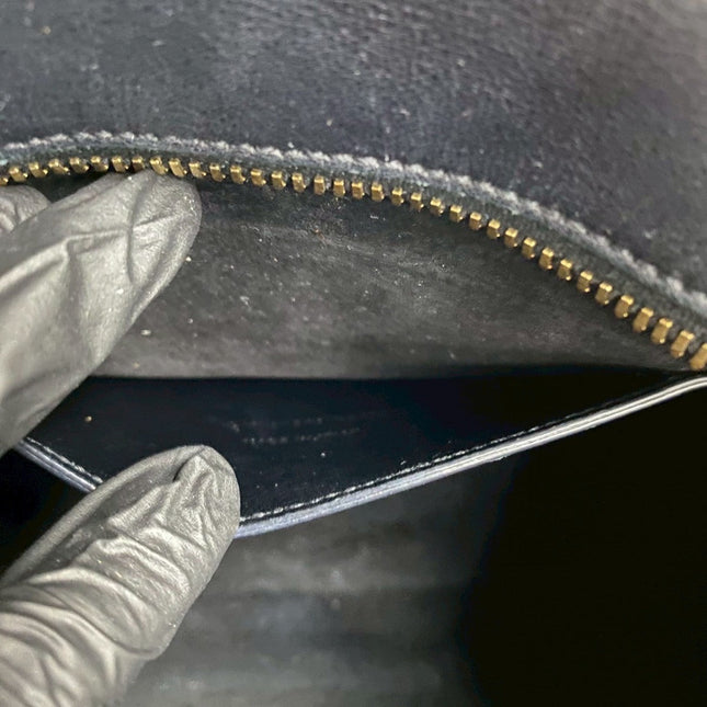 Inside view of a pre-owned SAINT LAURENT bag with a gold zipper and soft lining